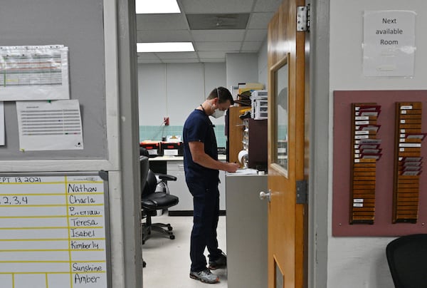 In this file photo from September, Dr. Jason Laney looks through charts at Jeff Davis Hospital in Hazlehurst. Dr. Jason Laney, a family medicine doctor who is the closest thing this tiny rural Georgia hospital has to a doctor who's trained in critical care, and has been leading the charge against COVID-19. (Hyosub Shin / Hyosub.Shin@ajc.com)