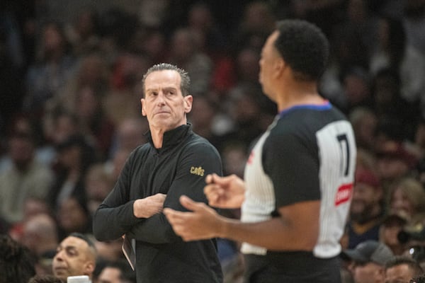 Cleveland Cavaliers head coach Kenny Atkinson, left, gives a look at referee Karl Lane, right, during the first half of an NBA basketball game against the Brooklyn Nets in Cleveland, Saturday, Nov. 9, 2024. (AP Photo/Phil Long)