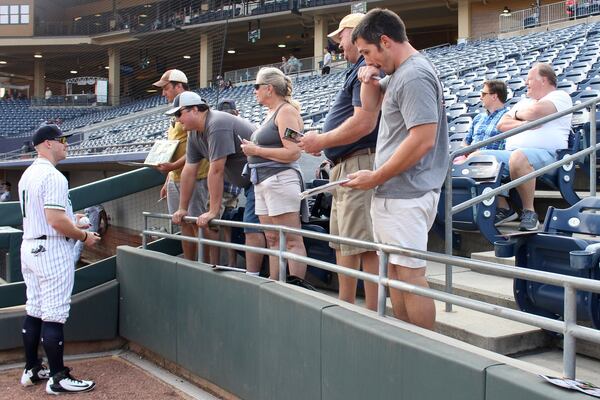 Gwinnett Stripers’ Michael Reed signs autographs for Stripers fans before their game against the Louisville Bats in a minor league baseball game at Coolray Field on Monday, August 13, 2018, in Lawrenceville. JENNA EASON / JENNA.EASON@COXINC.COM