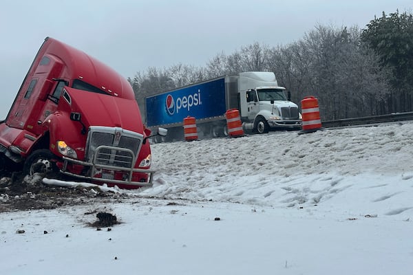 A tractor-trailer hauling a load of oranges sits on the side of the road after sliding off the Maine Turnpike early on Wednesday, Dec. 11, 2024, in New Gloucester, Maine. (AP Photo/David Sharp