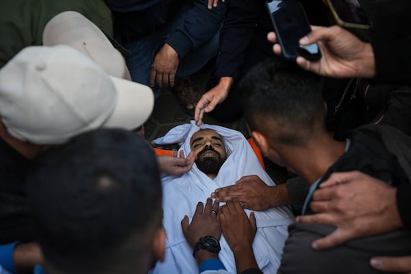 Palestinians mourn their relatives killed in the Israeli bombardment of Maghazi in the Gaza Strip, during their funeral at a hospital morgue in Deir al-Balah, Gaza, Thursday, Nov. 14, 2024. (AP Photo/Abdel Kareem Hana)