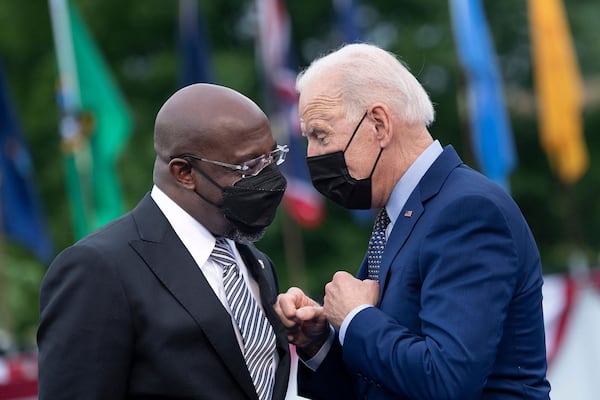 U.S. Sen. Raphael Warnock, left, has put some distance between himself and President Joe Biden, telling audiences on the campaign trail that he helped buck a White House plan to close a Savannah military installation, aggressively lobbied Biden to forgive student debt and badgered him to support a federal gas tax break. (Brendan Smialowski/AFP via Getty Images/TNS)