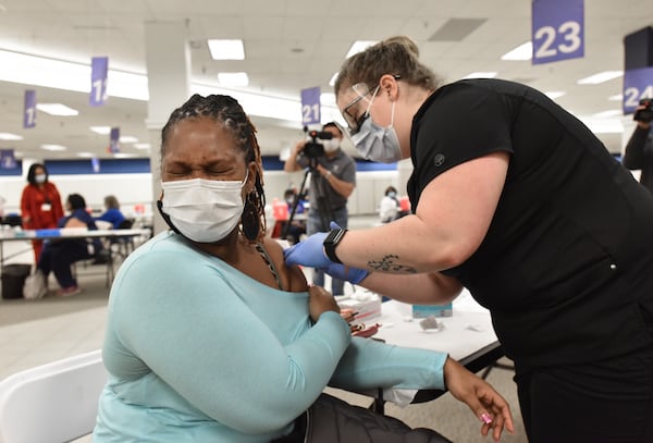 Nurse Kacy Bagwell gives a health care worker Martha Lynch (left) a COVID-19 vaccine ahead of the opening of the mass COVID-19 vaccination center at the former Sears building in Gwinnett Place Mall in Duluth on Feb. 5. Gwinnett County Government and the Gwinnett, Newton and Rockdale County Health Departments worked together to convert the bottom floor of the former Sears building at Gwinnett Place Mall into a mass vaccination center that will accommodate immunizing up to 3,000 people a day as vaccines become available, (Hyosub Shin / Hyosub.Shin@ajc.com)