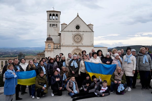 A group of Ukrainian faithful from Ivan-Frankivsk pose for a picture outside St. Francis Basilica in Assisi, Italy, Saturday, March 1, 2025. (AP Photo/Gregorio Borgia)