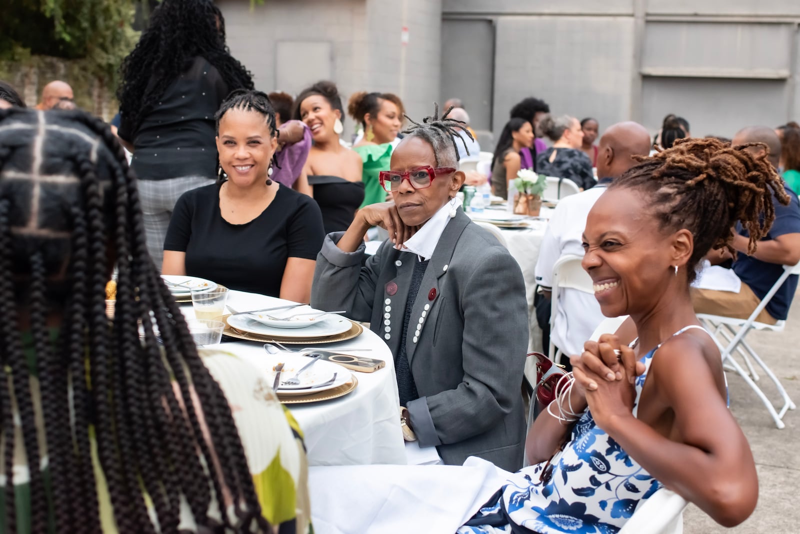 Members of The Tenth converse during a supper club event held at Atlanta Contemporary on August 25, 2024.