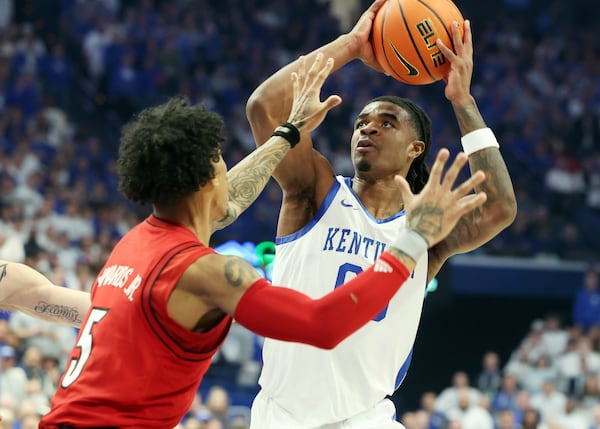 Kentucky's Otega Oweh, right, looks to shoot while pressured by Louisville's Terrence Edwards Jr. (5) during the first half of an NCAA college basketball game in Lexington, Ky., Saturday, Dec. 14, 2024. (AP Photo/James Crisp)