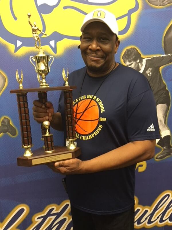  Samuel Favers holds a replacement trophy presented Friday to the 1968-69 Decatur basketball team, one of the first fully integrated teams in the state. (Photo/Maureen Downey)