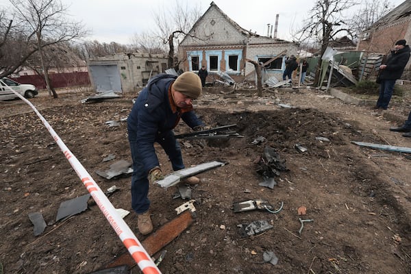 A police forensic expert inspects fragments of a Shahed drone, after a Russian strike on residential neighbourhood in Zaporizhzhia, Ukraine, Monday Nov. 25, 2024. (AP Photo/Kateryna Klochko)