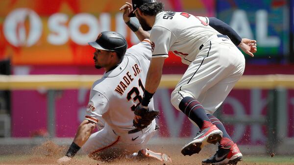 San Francisco Giants' LaMonte Wade Jr. (left) steals second base past Braves shortstop Dansby Swanson in the third inning Sunday, Aug. 29, 2021, at Truist Park in Atlanta. (Ben Margot/AP)