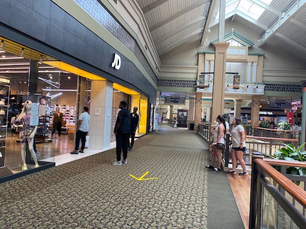 A line forms outside JD, a shoe store, at the Mall of Georgia on Monday.