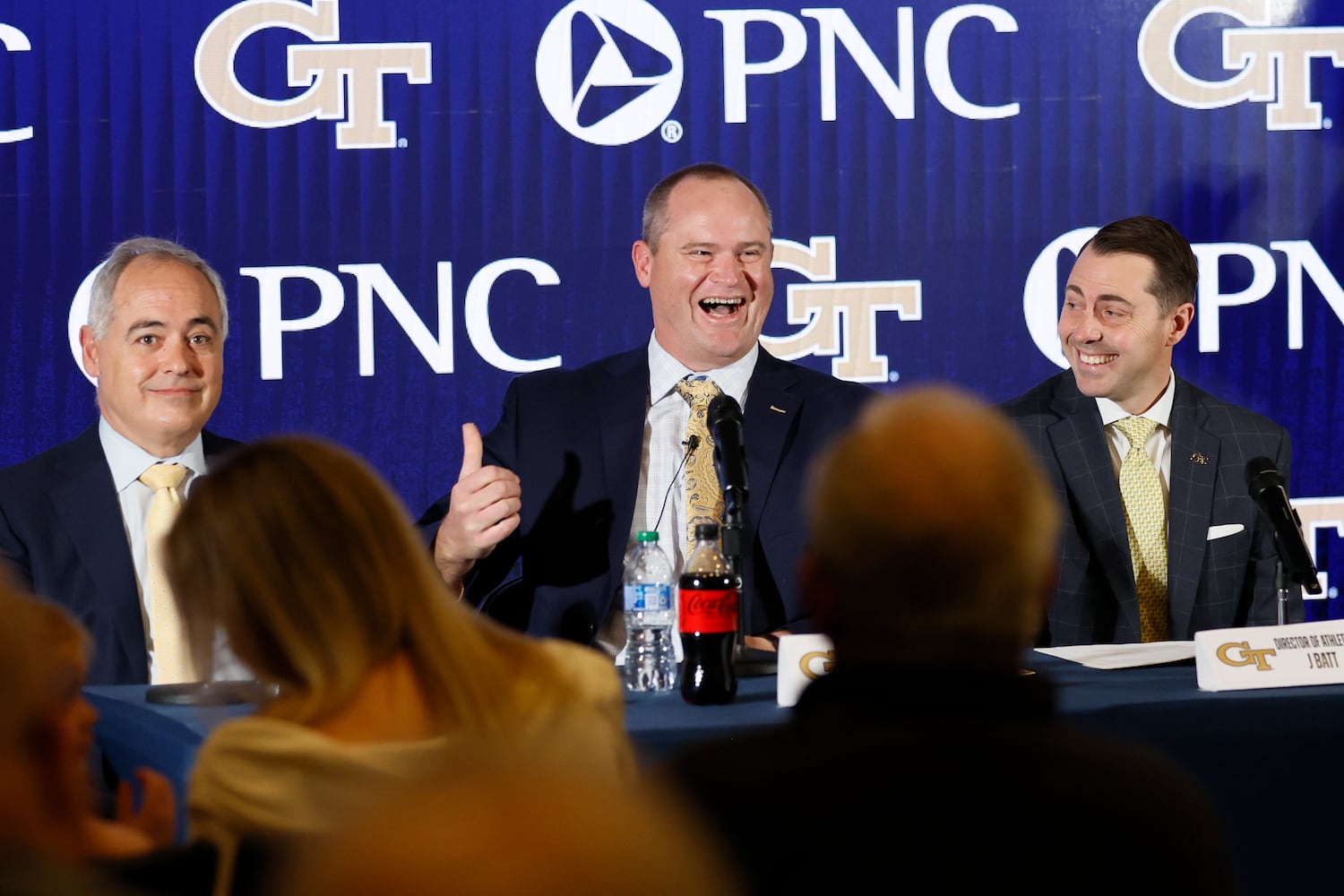 Georgia Tech's new head football coach Brent Key (center) reacts as he answers questions from the media during his introductory news conference as Tech President Angel Cabrera (left) and atheltic director J Batt (right) look on Monday, Dec. 5, 2022.
 Miguel Martinez / miguel.martinezjimenez@ajc.com