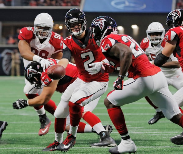 Atlanta Falcons quarterback Matt Ryan (2) hands off to running back Tevin Coleman (26) during the exhibition game against the Arizona Cardinals Saturday, Aug. 26, 2017, at Mercedes-Benz Stadium in Atlanta.