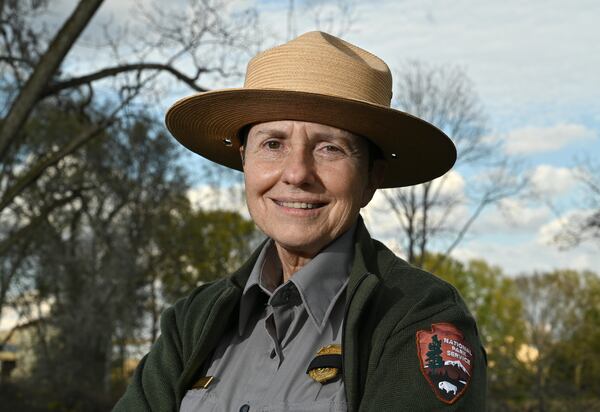 Jill Stuckey, the historic park’s superintendent, wore a black ribbon over her gold National Park Ranger badge Tuesday. She pointed to the big black bows her colleagues placed upon the wreaths decorating the Plains High School’s entrance. Plains, she said, aims to give former First Lady Rosalynn Carter “the best farewell we possibly can.” (Hyosub Shin / Hyosub.Shin@ajc.com)