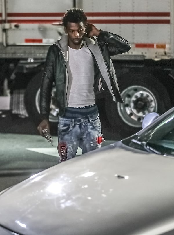 Jalen Jackson surveys the damage to his car after he and his fiancee were caught in the crossfire of a shooting Wednesday morning at a South Fulton Taco Bell.