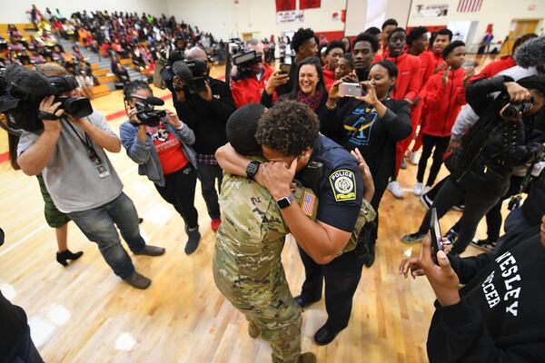 Atlanta Public Schools police officer L.J. Williamson and her son, U.S. Army specialist Shakir Aquil, leave a pep rally after he surprised her with his homecoming Friday, Jan. 17, 2020, in Atlanta. JOHN AMIS