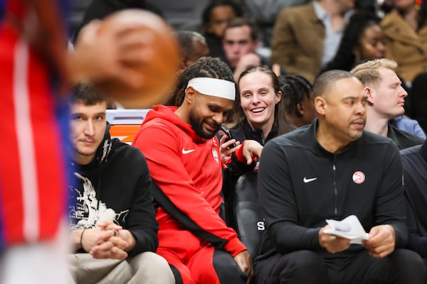 Hawks assistant coach Brittni Donaldson talks with Hawks guard Patty Mills, left, on the bench during the Hawks’ game against the Detroit Pistons at State Farm Arena, Monday, December 18, 2023, in Atlanta (Jason Getz / Jason.Getz@ajc.com)