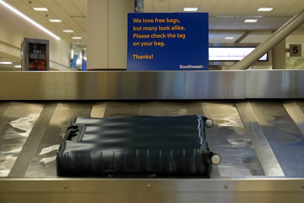 Southwest Airlines signage is displayed at baggage claim at Midway International Airport, Tuesday, March 11, 2025, in Chicago. (AP Photo/Erin Hooley)