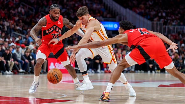 Hawks guard Bogdan Bogdanovic dribbles through defenders during Saturday's home loss to Toronto.