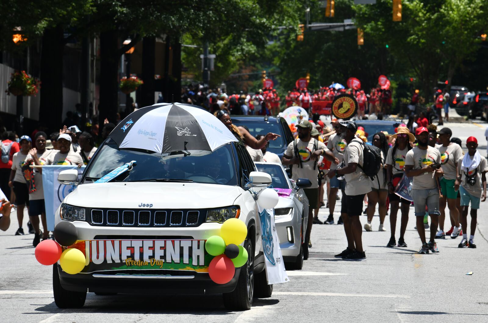 June 18, 2022 Atlanta - The parade makes its way into Centennial Olympic Park during the Juneteenth Atlanta Black History Parade on Saturday, June 18, 2022. The 10th annual Juneteenth Atlanta Parade & Music Festival is a four-day free music festival that also includes a black history parade. Juneteenth, a June 19 holiday, recognizes the last African American slaves being freed in 1865, more than two years after the Emancipation Proclamation was signed. Now a federal holiday, Juneteenth celebrates African American freedom, history, culture, achievements and more with a variety of commemorative events including history lessons, art, music and empowerment programs. (Hyosub Shin / Hyosub.Shin@ajc.com)