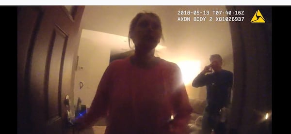 Katie Kettles Sasser at her front door the night of May 13, 2018, as officers answer a domestic incident involving her estranged husband Lt. Robert C. Sasser. This photo is from police body cam footage. The man in the background is John Hall Jr. Both Kettles Sasser and Hall were fatally shot by Lt. Sasser on June 28, 2018, at Hall’s home. Sasser then killed himself with a gunshot in a SWAT incident at his home.