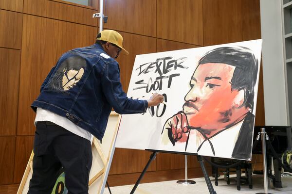 Artist Dakoro Edwards created a live painting depicting Dexter Scott King at Sandy Springs City Hall on February 1, 2024 to kick off the city's Black History Month programming. (Jason Getz / jason.getz@ajc.com)