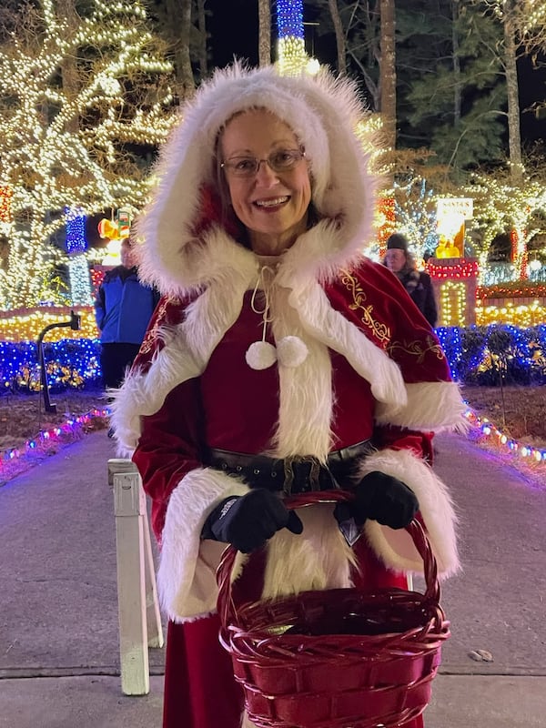 Sherrie Taylor gets into the Christmas spirit while greeting visitors to Lights of Joy. Courtesy of Richard Taylor