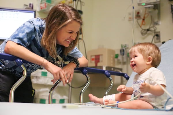 In this 2016 file photo, Amelia Ballard, a pediatric nurse at Children’s Healthcare of Atlanta’s Egleston location, treats her patient, Olen, who is 8 months old, in the emergency room. Ballard worked in the emergency department at Children's before working at the Children's Aflac Cancer and Blood Disorders Center (Emily Jenkins / AJC file photo)