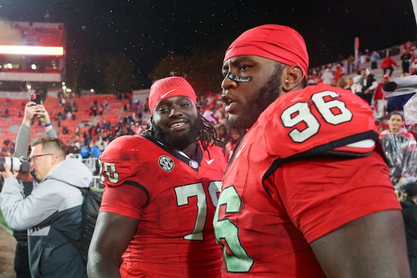 Georgia defensive lineman Nazir Stackhouse (78) and Georgia defensive lineman Zion Logue (96) celebrate their win against Ole Miss at Sanford Stadium, Saturday, November 11, 2023, in Athens, Ga. Georgia won 52-17. (Jason Getz / Jason.Getz@ajc.com)