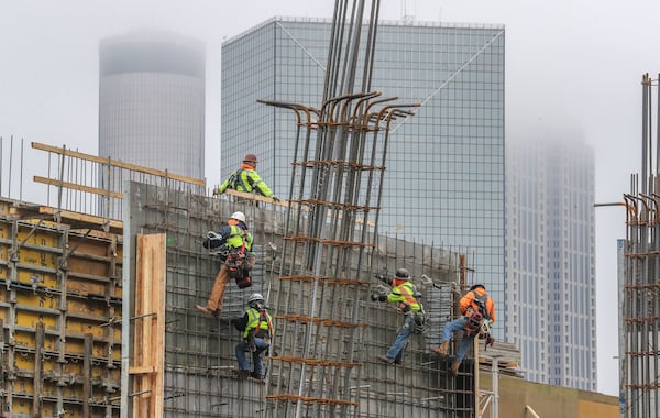 Overall, metro Atlanta added 72,000 jobs last year. The construction sector, which has about 146,000 workers, grew by 4,700. Here, workers on an 18-story, 304-unit apartment tower being built across from Mercedes-Benz Stadium near downtown. (John Spink / John.Spink@ajc.com)