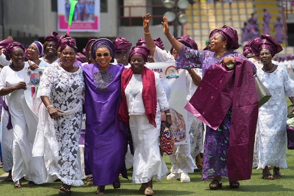 Women sing and march during the International Women's Day celebration at the Mobolaji Johnson Stadium in Lagos, Nigeria, Friday, March 7, 2025. (AP Photo/Sunday Alamba)