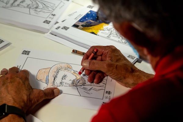 Jay Bear draws a picture of Vincent van Gogh while visiting the "Van Gogh: The Immersive Experience" at the Pullman Yard in Atlanta Thursday, May 20, 2021. STEVE SCHAEFER FOR THE ATLANTA JOURNAL-CONSTITUTION