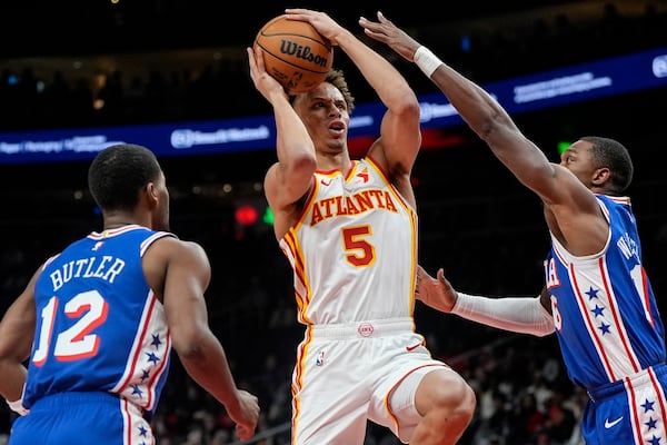 Atlanta Hawks guard Dyson Daniels (5) shoots against Philadelphia 76ers guard Lonnie Walker IV (16) during the first half of an NBA basketball game, Monday, March 10, 2025, in Atlanta. (AP Photo/Mike Stewart)