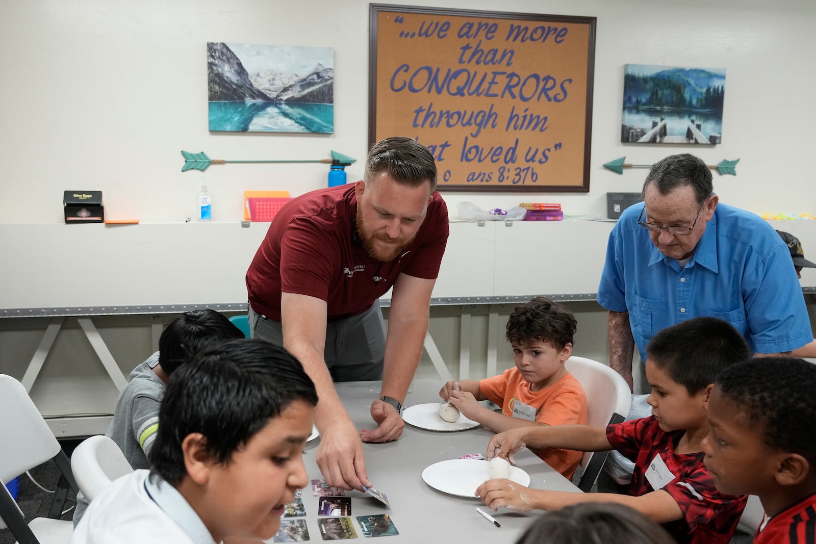 Trevor Cowling helps out during an activity class at a summer camp for youth at Valley Baptist Church Tuesday, June 18, 2024, in Mesa, Ariz. (AP Photo/Ross D. Franklin)