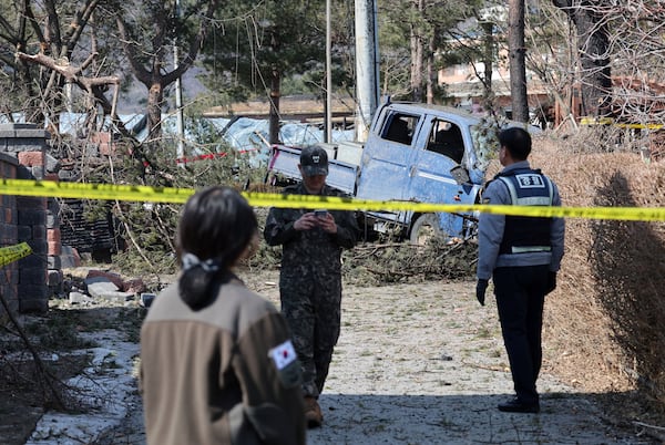 South Korea army soldier police officer stand guard near a bomb accident site where a South Korean fighter jet accidentally dropped bombs on a civilian area during training, in Pocheon, South Korea, Thursday, March 6, 2025. (Yonhap via AP)