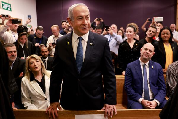 Israeli Prime Minister Benjamin Netanyahu, center, arrives to attend a hearing at the district court for his long-running trial for alleged corruption, in Tel Aviv, Israel, Tuesday, Dec. 10, 2024. (Menahem Kahana/Pool Photo via AP)