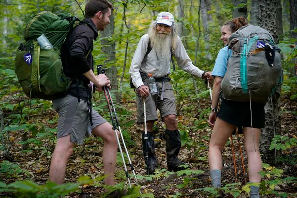 M.J. Eberhart, 83, center, shares trail information with a pair of thru-hikers on the Appalachian Trail in Gorham, New Hampshire. Eberhart is the oldest person to hike the entire 2,193-mile Appalachian Trail. (AP Photo/Robert F. Bukaty)