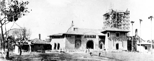 A rare photograph shows Mar-a-Lago under construction with its tower sheathed in scaffolding. A press report at the time of construction described the house as “the largest residential undertaking in the resort’s history.” Courtesy Historical Society of Palm Beach County