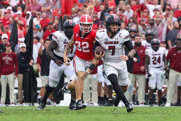 South Carolina quarterback Spencer Rattler (7) rushes for a first down against Georgia linebacker Chaz Chambliss (32) during the first half at Sanford Stadium, Saturday, September 16, 2023, in Athens, Ga. (Jason Getz / Jason.Getz@ajc.com)