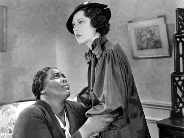 In the 1934 film “Imitation of Life,” Fredi Washington, right, plays Peola, the daughter of Louise Beavers, left, and breaks her mother’s heart by passing as a white woman. (Universal Pictures)