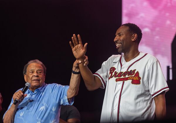 Former Mayor of Atlanta Andrew Young raises the hand of Mayor Andre Dickens during the 50th Anniversary Hip Hop Concert at Lakewood Amphitheater in Atlanta on Sunday, August 13, 2023 in Atlanta. (Michael Blackshire/Michael.blackshire@ajc.com)