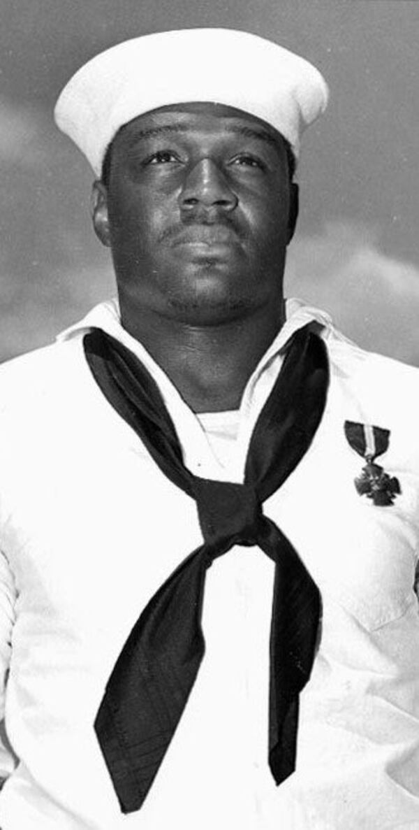 Doris "Dorie" Miller, USN mess attendant second class, May 27, 1942, after presentation of the Navy Cross by Adm. Chester W. Nimitz aboard the USS Enterprise.