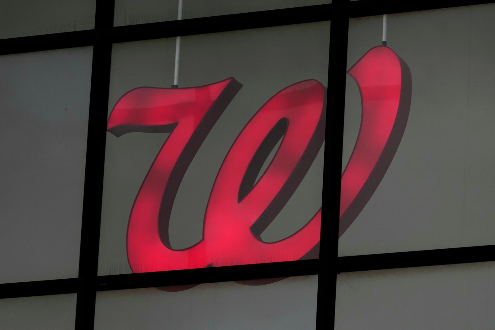 A Walgreens logo is seen from the exterior of a store in Wheeling, Ill., Tuesday, Oct. 15, 2024. (AP Photo/Nam Y. Huh)