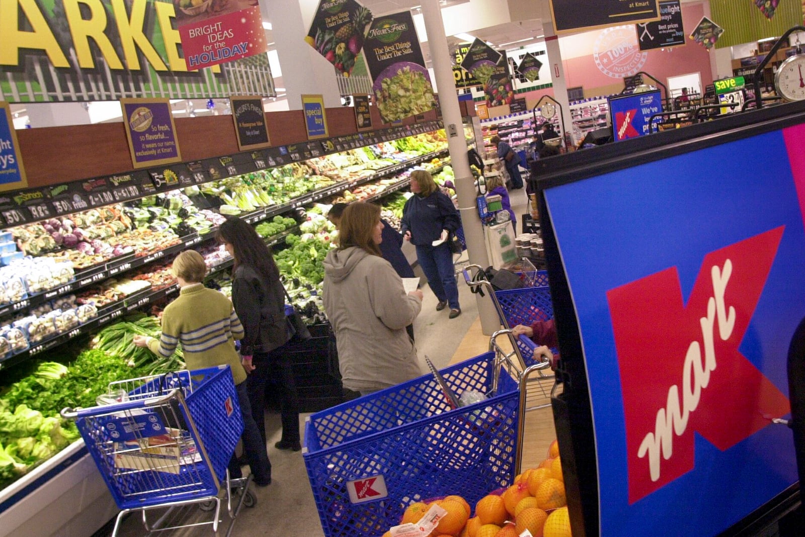 FILE - Shoppers look for groceries at a Kmart store in Bloomfield Hills, Mich., on Nov. 21, 2001. (AP Photo/Paul Sancya, File)