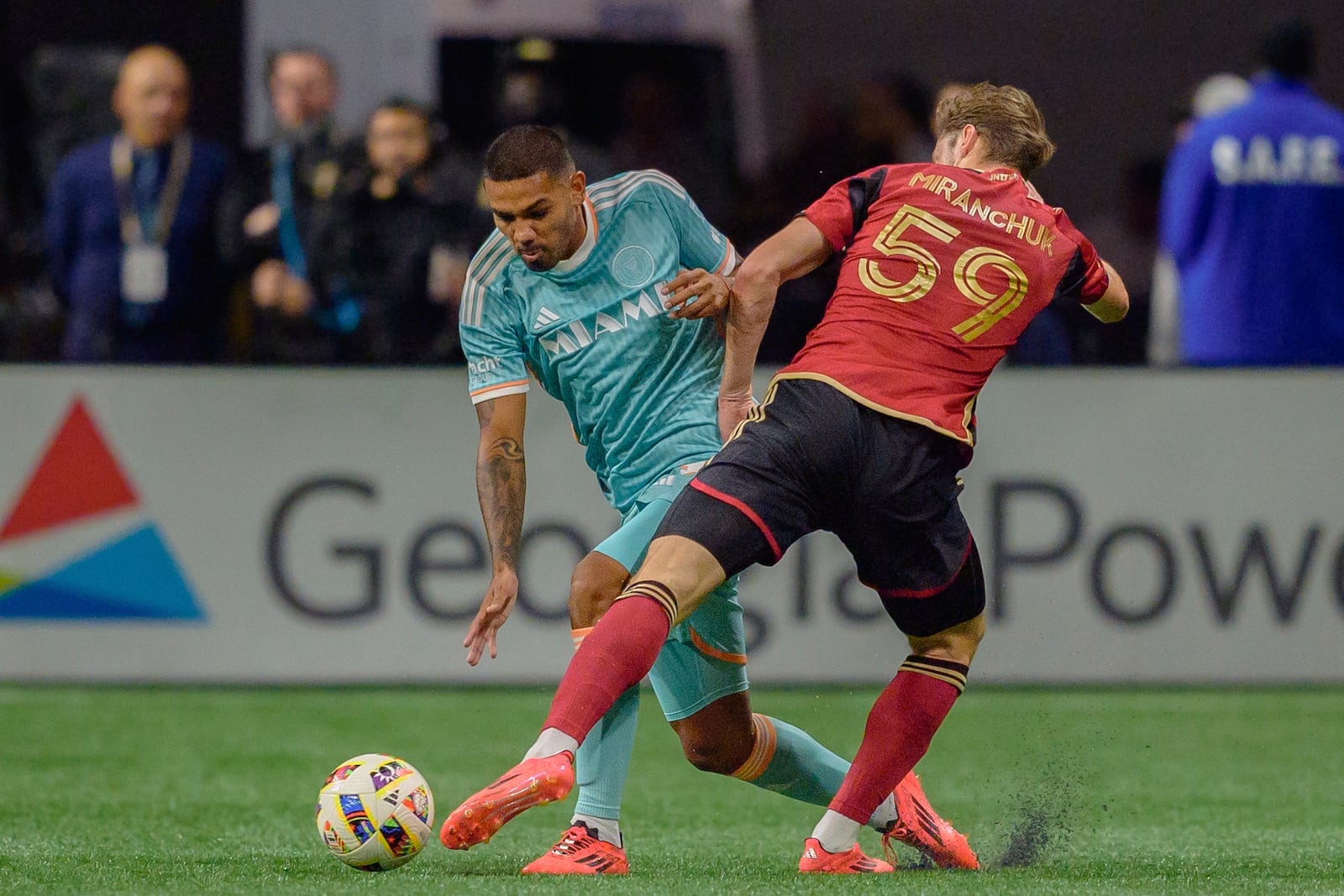 Atlanta United midfielder Aleksey Miranchuk (59) attempts to steal the ball from Inter Miami defender David Martínez during the first half of an MLS soccer match Saturday, Nov. 2, 2024, in Atlanta. (AP Photo/Jason Allen)