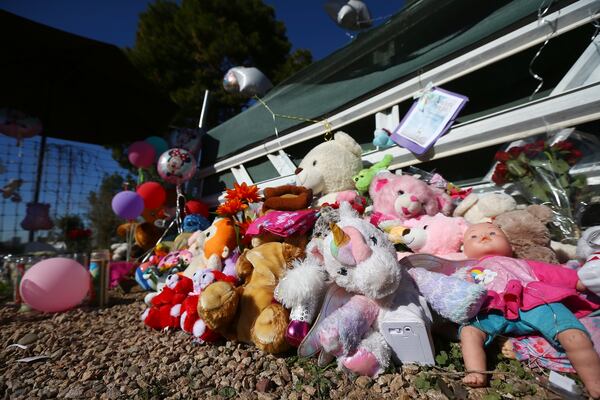 A makeshift memorial grows in front of the home where Rachel Henry was charged with killing her three children. The children were found dead inside the family home  in Phoenix. 