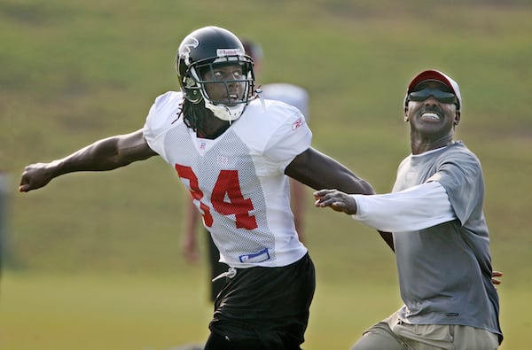 Falcons assistant strength-and-conditioning coach Billy "White Shoes" Johnson, right, a former Pro Bowl player, shows he still has a little left in the tank as he steps in to cover Falcons wide receiver Roddy White as he runs a pass route drill during morning practice at Flowery Branch, Monday, August 6, 2007.   (PHOTO BY CURTIS COMPTON/AJC staff)