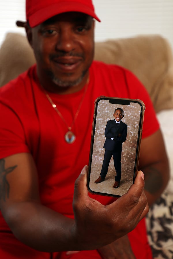 Lavell Ingram displays a photo of his son, Kaden Harris-Ingram, while at home in Chicago this week.