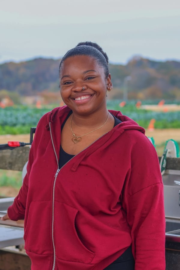 Aliyah Williams, 22, a Black fifth-year student at the University of Georgia from Lawrenceville., Georgia completes a food delivery with Campus Kitchen and UGArgen which she was inspired to join in part due to her personal encounters with food insecurity growing up with three siblings. Williams poses for a portrait at UGArden in Athens, Georgia on Friday, Nov. 10, 2023. (Photo Courtesy of Samantha Hurley)