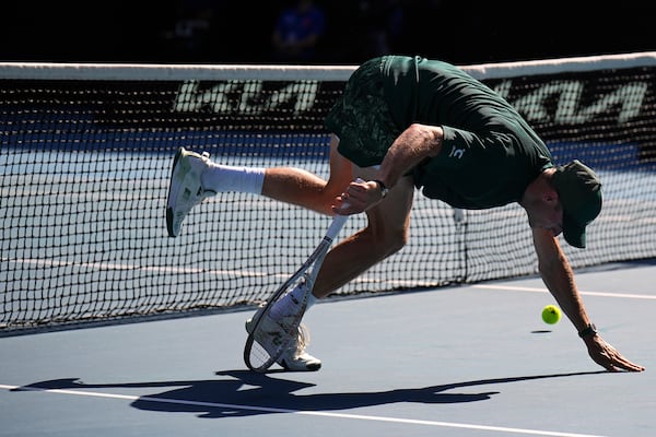 Tommy Paul of the U.S. reacts after an attempted backhand return to Alexander Zverev of Germany during their quarterfinal match at the Australian Open tennis championship in Melbourne, Australia, Tuesday, Jan. 21, 2025. (AP Photo/Vincent Thian)