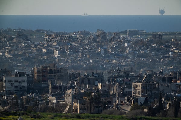 Buildings destroyed during the Israeli air and ground offensive stand in the Gaza Strip are seen from southern Israel, Sunday, March 2, 2025. (AP Photo/Leo Correa)